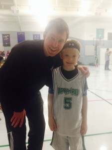 Austin posing with me his coach at an Upward game.
